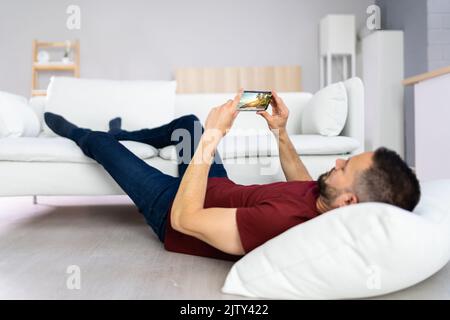 Man With Lethargy And Fatigue On Couch Or Sofa Stock Photo