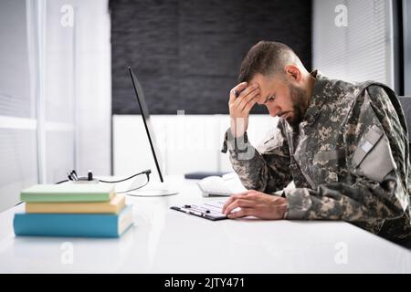Sad Frustrated Military Veteran Student Doing Test In College Stock Photo