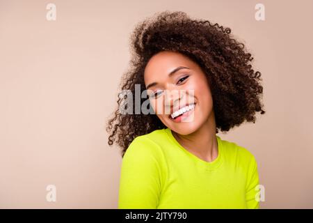 Photo of dreamy sweet lady wear yellow shirt smiling white teeth empty space isolated beige color background Stock Photo