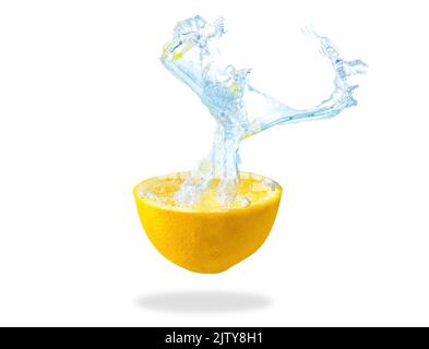 Lemon half dropped in water with splashes Stock Photo