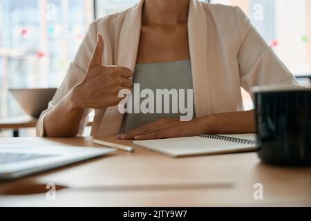 Woman shows hand gesture that everything is fine in office Stock Photo