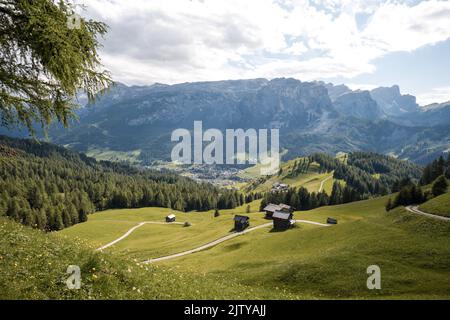 The scattered small houses on lush green hill in a rural area Stock Photo