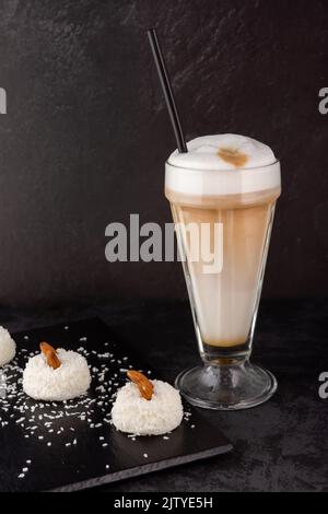 close-up of a barista preparing coffee with syrup and cream foam in a shop or cafe for a dessert of souffle cakes Stock Photo