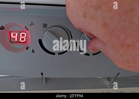 Manually changing hot water temp-Reducing fuel bill, lowering Condensing Central Heating boiler temperature for hot water - Baxi Platinum Stock Photo