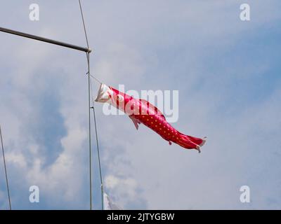 Carp streamers (koinobori) on the boat mast. Koinobori is a symbol of strength, persistence, bravery and success. Stock Photo