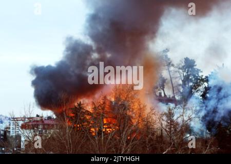 Strong house fire, a fire and black column of smoke. Blurred image Stock Photo
