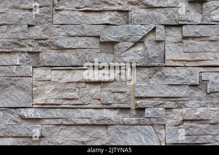 fake stone wall, plastic panel imitating natural slab wall brickwork Stock Photo