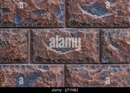 fake brick wall, plastic panel imitating natural stone blocks wall brickwork Stock Photo