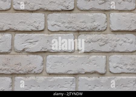 fake white brick wall, plastic panel imitating natural brickwork Stock Photo