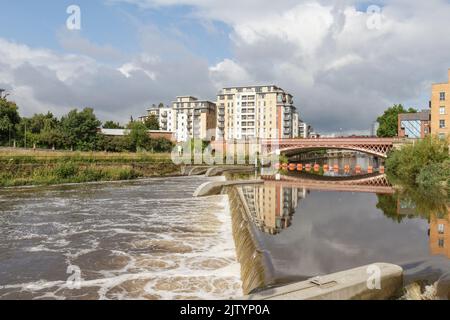 Weir on the River Aire looking towards Crown Point bridge in Leeds, West Yorkshire, UK. Stock Photo