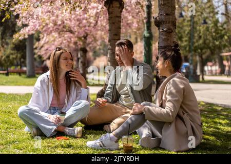 Group of young attractive smiling students dressed casual having fun on campus at the university. Stock Photo