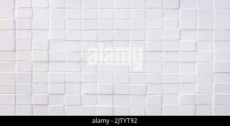 White painted, uneven brick wall Stock Photo