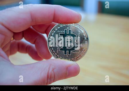 holding the coin of the future between my fingers is great Stock Photo