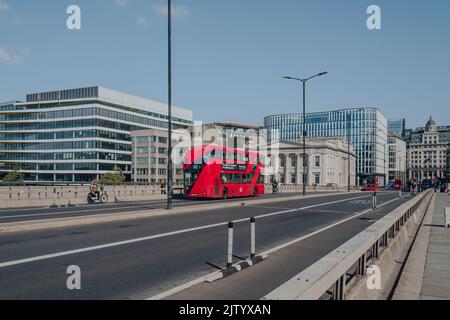 London, UK - August 26, 2020: Red double decker bus and cyclists on London Bridge. Double decker bus is an iconic symbol of the city. Stock Photo