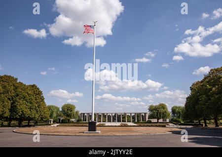 Henri-Chapelle American Cemetery and Memorial, US military cemetery near Welkenraedt, Wallonia, Belgium. Tall pole with Stars and Stripes flag and gol Stock Photo