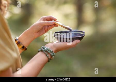 woman with palo santo performing magic ritual Stock Photo