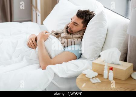 sick man sleeping in bed at home Stock Photo