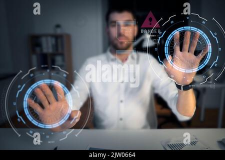 businessman using virtual screen at night office Stock Photo