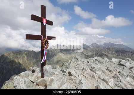 Cross at the summit of Krivan a mountain in the High Tatras of Slovakia, Europe Stock Photo