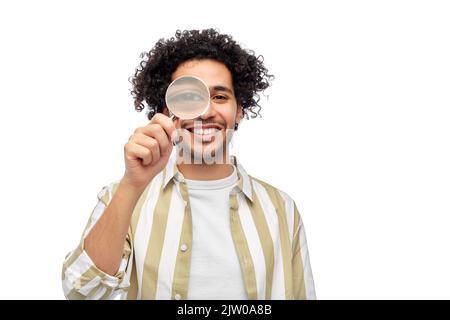 happy man looking through magnifying glass Stock Photo