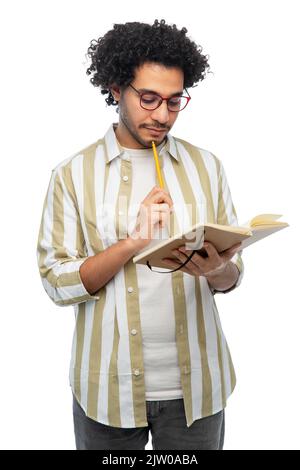 thinking young man with diary and pencil Stock Photo
