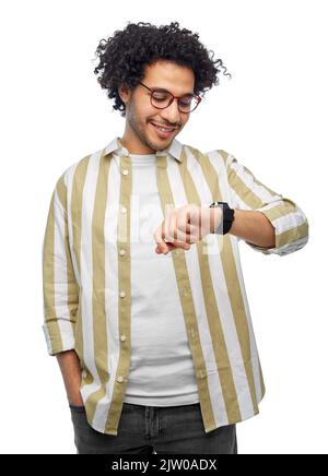 smiling young man in glasses with smart watch Stock Photo