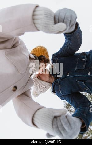 happy couple kissing in winter park Stock Photo