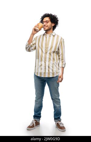 smiling young man with takeaway coffee cup Stock Photo