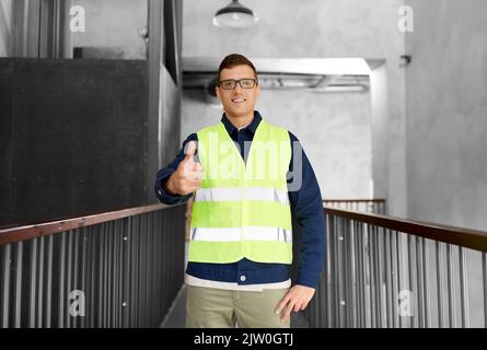 male worker in safety west showing thumbs up Stock Photo
