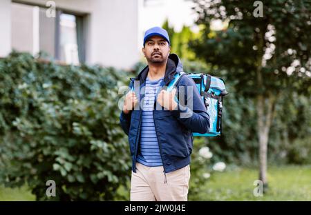 indian delivery man with bag in city Stock Photo