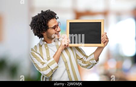 smiling man with chalkboard at office Stock Photo