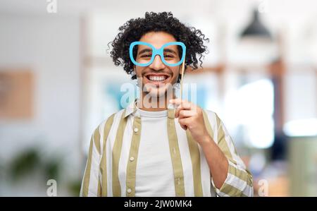 smiling man with glasses party accessory at office Stock Photo