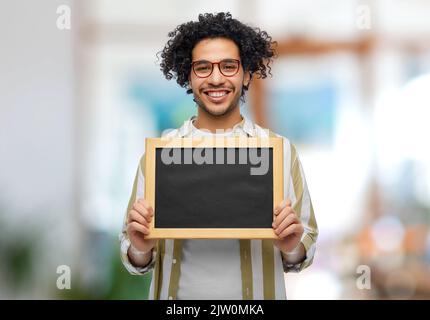 smiling man with chalkboard at office Stock Photo