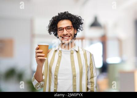 smiling man with takeaway coffee cup at office Stock Photo