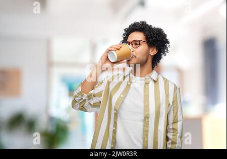 man drinking takeaway coffee at office Stock Photo