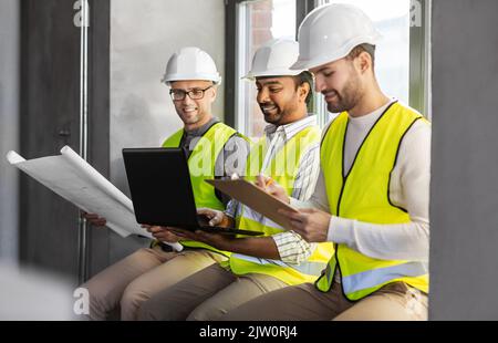 male architects in helmets working at office Stock Photo