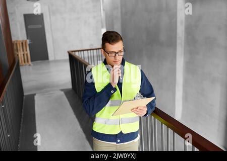 male worker with clipboard at office Stock Photo