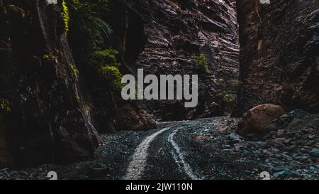 A narrow path in Wadi Lajab, Saudi Arabia, that takes visitors deeper into the valley. Stock Photo