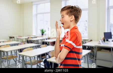 tired yawning student boy at school Stock Photo