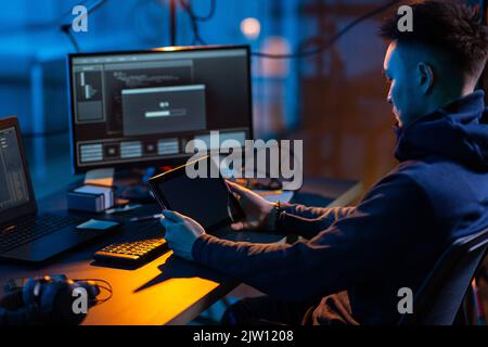 hacker using tablet pc computer for cyber attack Stock Photo