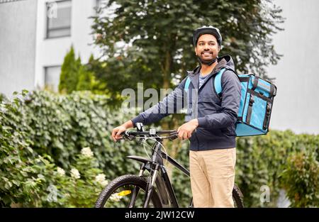 food delivery man with bag and bicycle in city Stock Photo