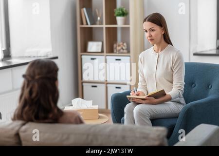 psychologist and woman at psychotherapy session Stock Photo