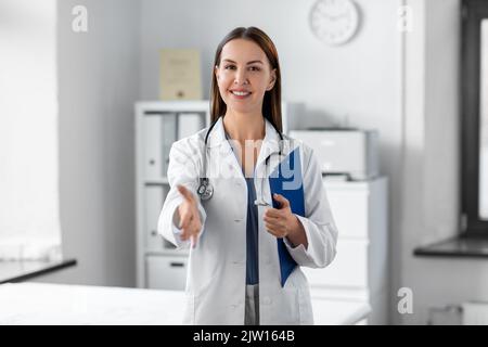female doctor giving hand for handshake at clinic Stock Photo