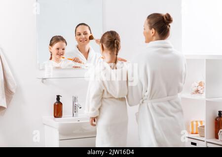 happy mother and daughter in bathroom Stock Photo