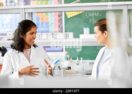 international female scientists talk in laboratory Stock Photo