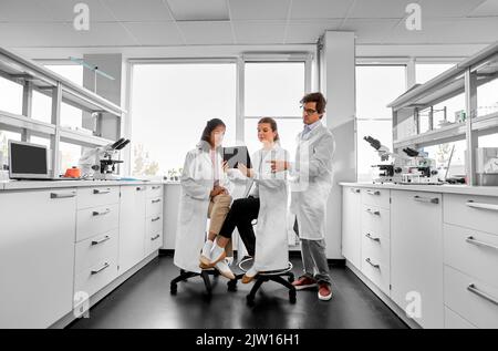 scientists with tablet pc working in laboratory Stock Photo