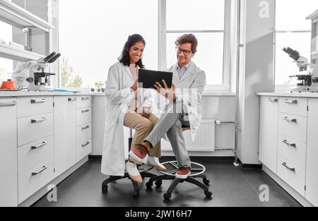 scientists with tablet pc working in laboratory Stock Photo