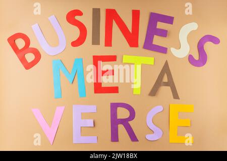BUSINESS METAVERSE inscription on a beige background. Metaverse is the next generation of the internet, an immersive and multi-sensory experience usin Stock Photo