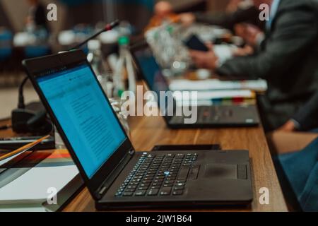 Photo of a laptop on a table in a modern seminar hall. Selective focus  Stock Photo