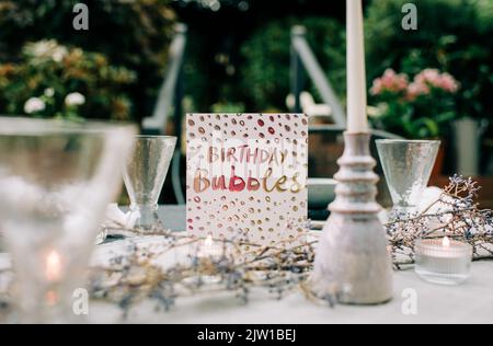 Happy birthday card on a decorated dinner table Stock Photo